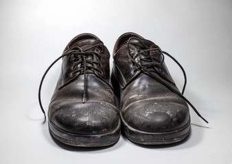 Dirty men's shoes sprinkled with whitewash.