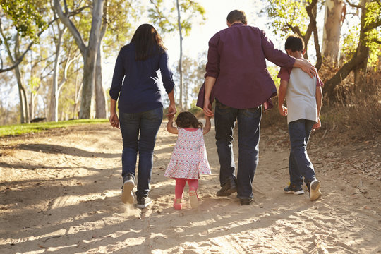 Mixed Race Family Walking On Rural Path, Close Up Back View