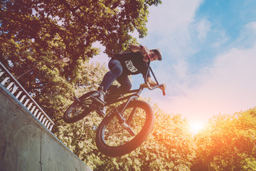 Boy jumping with his bmx in the park.