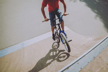 Boy riding a bmx in a park.