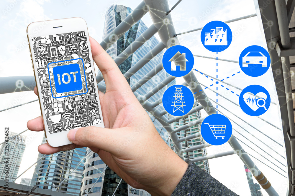 Poster internet of things concept .man hand holding smartphone and iot icon with building background