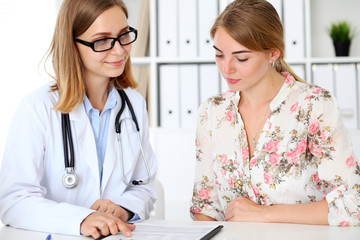 Doctor and  patient  sitting at the desk