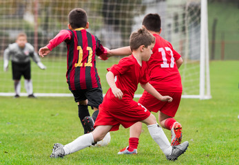 Obraz premium Boys kicking ball