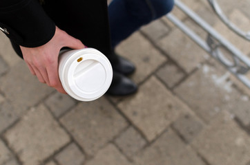 Young girl with a plastic cup of coffee