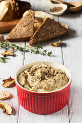 Mushroom pate on a white wooden background, vertical, selective focus

