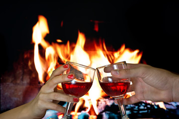 Hands holding glass of red wine