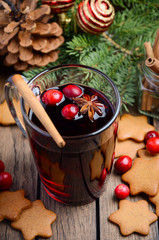 Christmas mulled wine. Holiday concept decorated with Fir branches, Gingerbread Cookies and Cranberries.