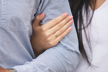 closeup of a woman's hand wearing engagement ring