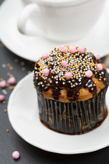 Chocolate muffin and cup of coffee, selective focus