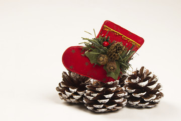 Fototapeta na wymiar Christmas decoration Santa and pine cone shoe. White background.