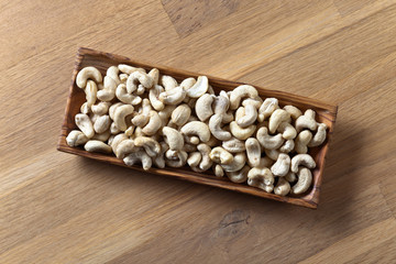 Cashews in old wooden dish