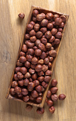 Hazelnuts in old wooden dish