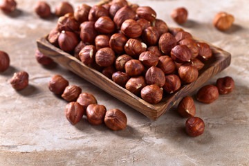 Hazelnuts in old wooden dish