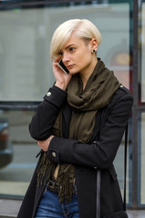 Fototapeta premium Young girl using her phone