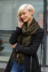 Fototapeta premium Young girl using her phone