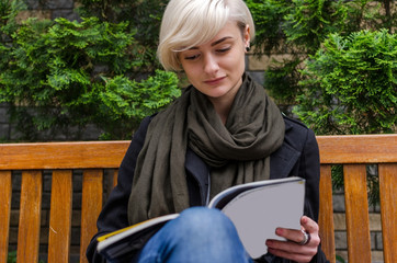 Young woman reading magazine