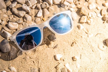 Fototapeta na wymiar Sunglasses on Rocky Beach