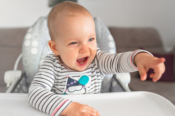 Cute little girl sitting on high chair