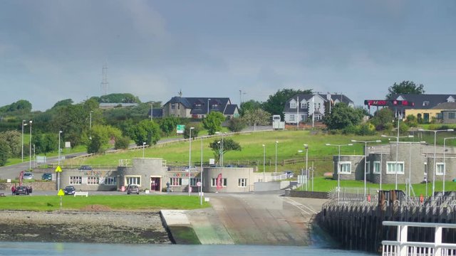 A landscape view of the Killimer village in Ireland it has bunk houses and a river