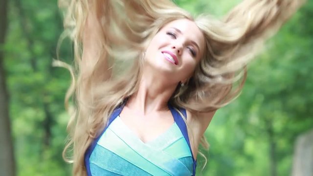Pretty blonde with long beautiful hair in nature
