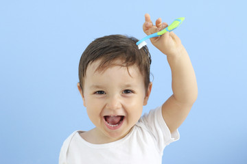 baby showing his toothbrush