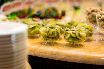 kiwi buffet, stylish luxury decorated candy bar for the celebration of a wedding, Fresh delicious kiwi  on the buffet table