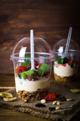 Fruit dessert and breakfast. Mousse with strawberries and nuts. On a wooden background.