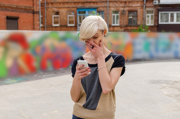 Fototapeta premium Young girl using her phone