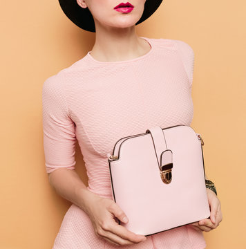 Girl in retro style. Accessories hat and bag. Vanilla style fash