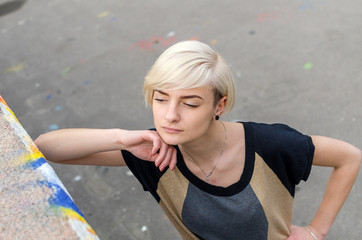 Young blonde girl walking on the city