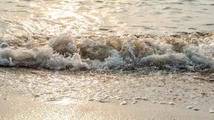 Sea surf with sunset light