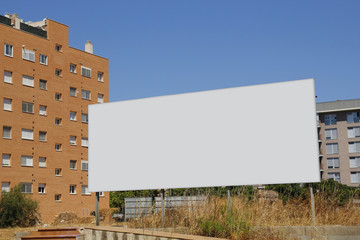 Blank billboard in front of new buildings