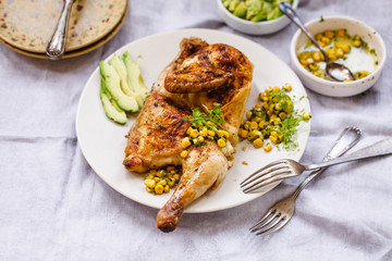 Chicken roasting with tortilla and avocado corn herb sauce. Chicken dish with tortilla wrap.
