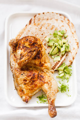 Chicken roasting with tortilla and avocado corn herb sauce. Chicken dish with tortilla wrap.