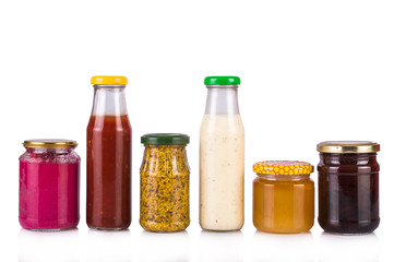 Bottled sauces. Jam and honey jars. On white, isolated background.