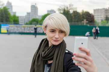 Fototapeta premium Young girl makes selfie