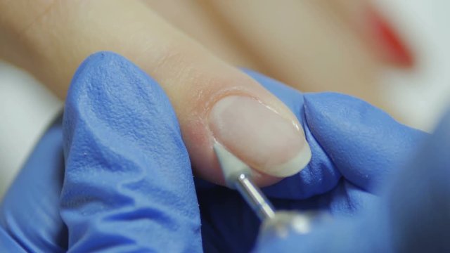 Manicurist makes manicure
