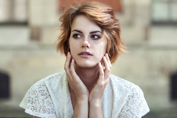 Young beautiful girl in white summer dress