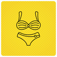 Fototapeta premium Lingerie icon. Women underwear sign. Linear icon on orange background. Vector