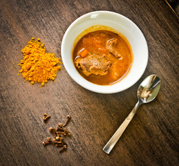 cup of steaming hot soup with spices