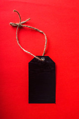 Black Friday. Black price tag. On red background.Top view. Flat lay.