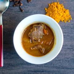 cup of steaming hot soup with spices