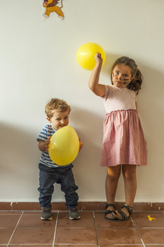 Children with yellow balloons having fun in kids party