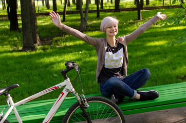 Young girl with bicycle in the park