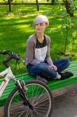 Young girl with bicycle in the park