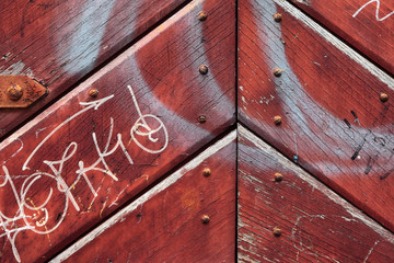 Urban painted red rusty wooden door background
