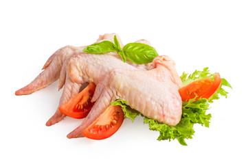 Chicken wings with basil, tomato and lettuce. On white, isolated background.
