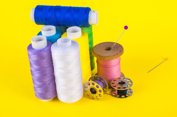 Different threads and pins. On a yellow background.