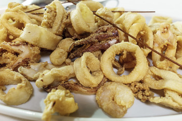 shrimp, squid and octopus fried in white dish