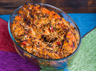 Vegetarian dish of baked orange pumkin, mixed vegetables, herbs,
